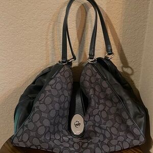 Black and gray coach matching shoulder purse and wallet with silver accent.